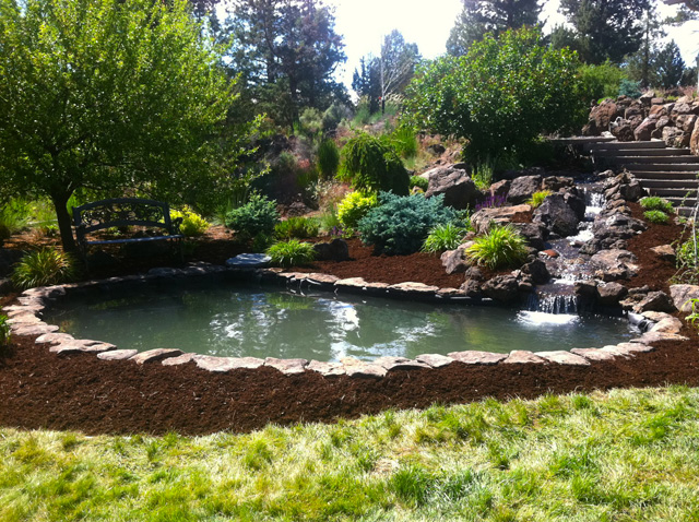Custom backyard water feature with flowing water