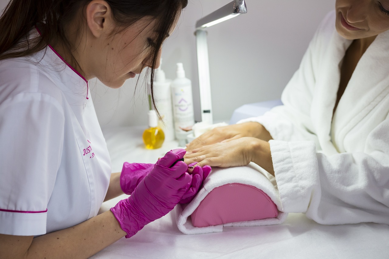 Nail technician applying pedicure treatment