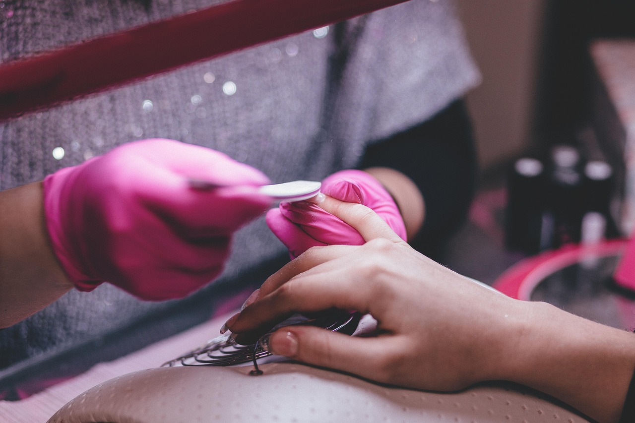 Hands receiving manicure treatment