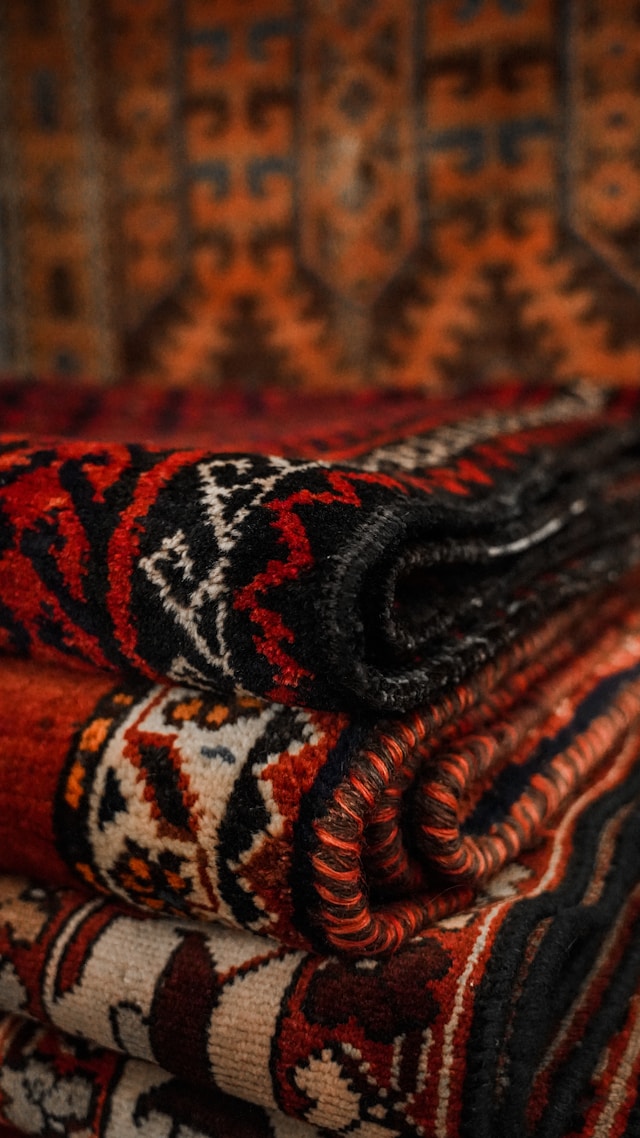 Close-up of a richly patterned area rug showing intricate hand-knotted craftsmanship