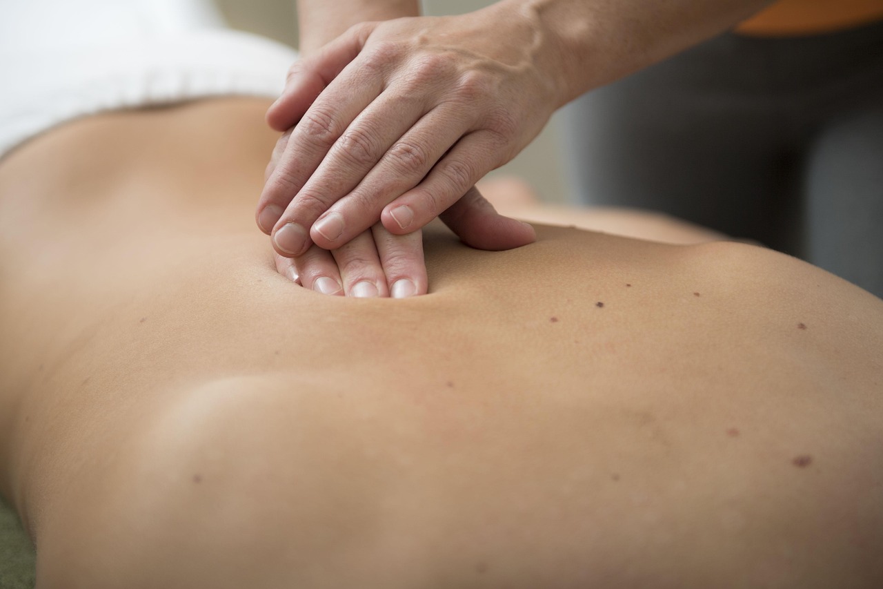 Therapist applying deep tissue massage technique to a client's back