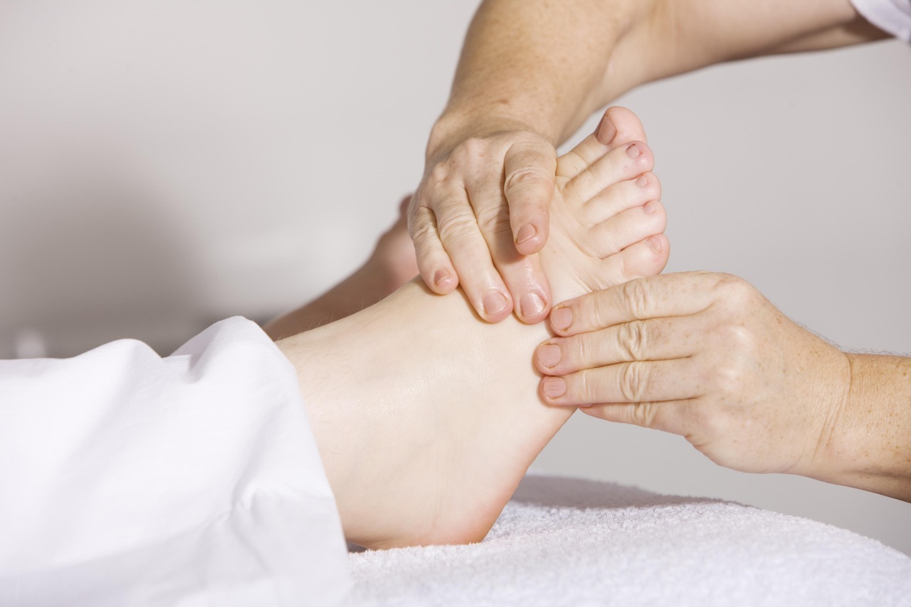 Therapist performing foot reflexology massage