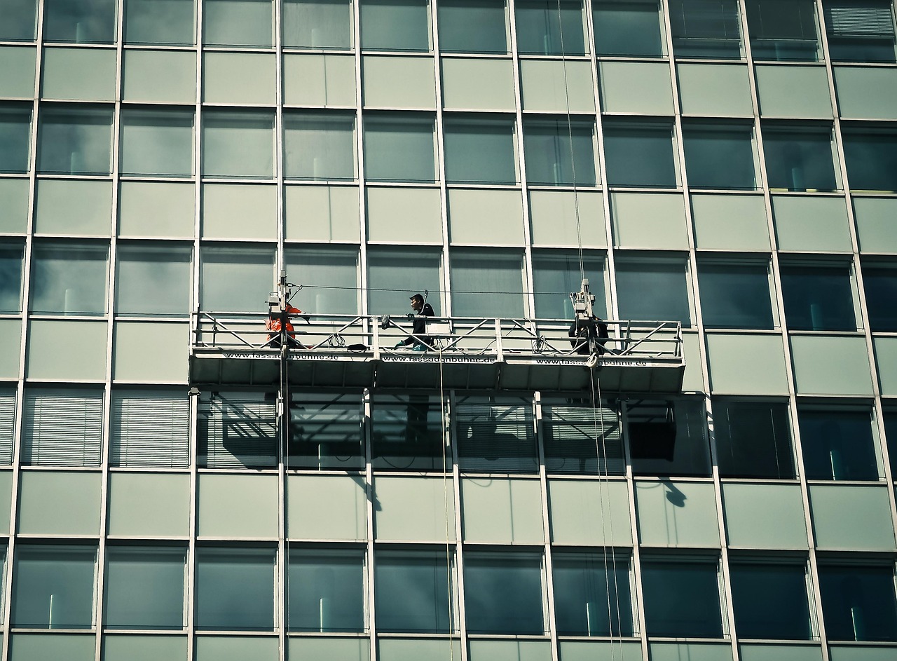 Window cleaners working on a high building facade in Central Oregon