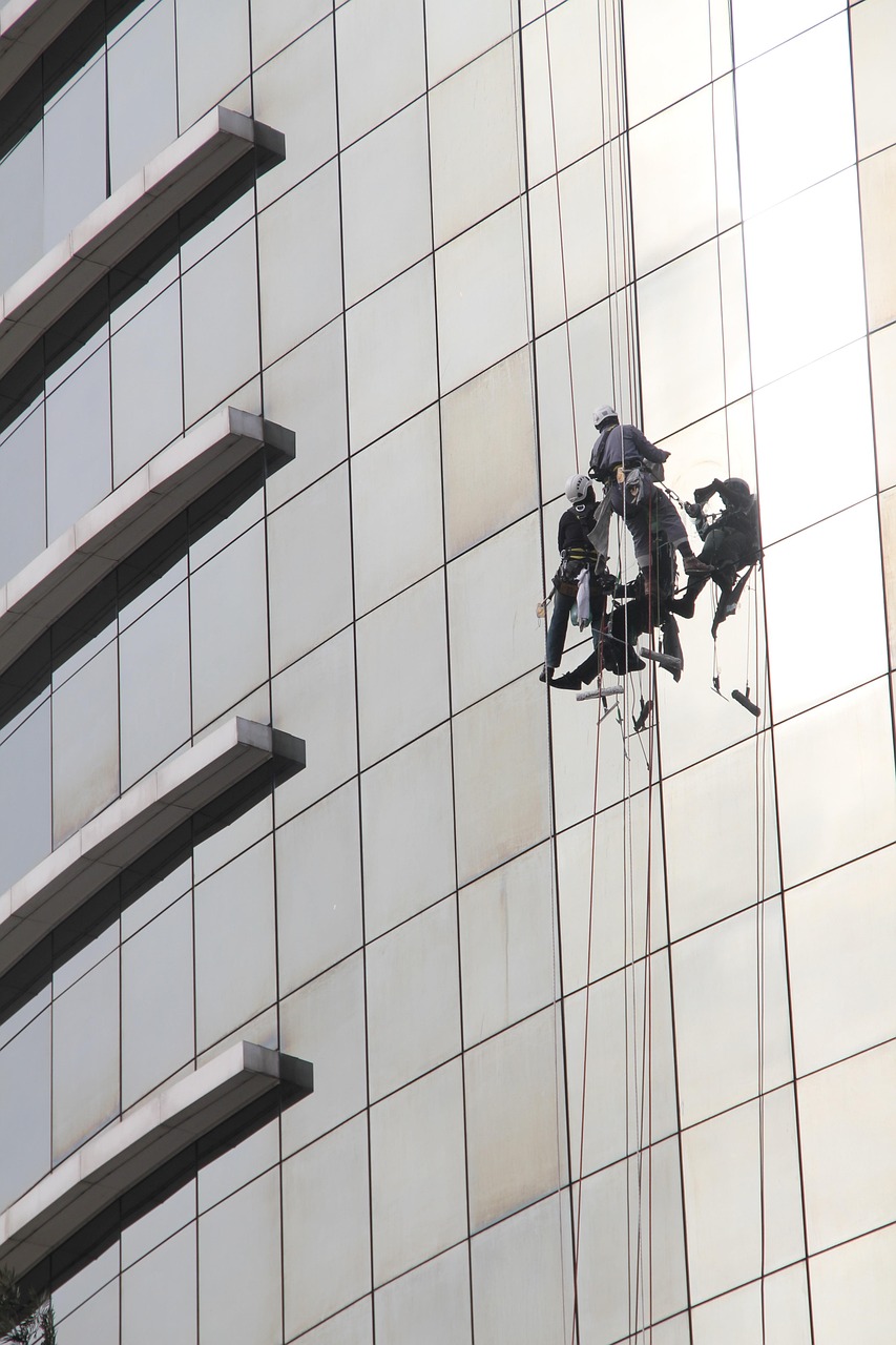 Professional window cleaner working on a high-rise building