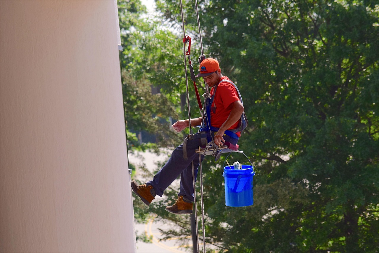 Professional window cleaner working on an elevated building exterior