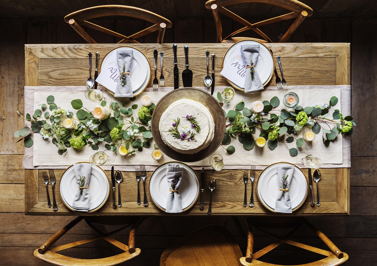 Elegantly set dining table with fresh flowers and fine tableware
